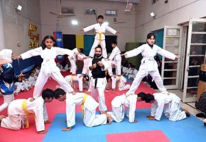 Martial arts students demonstrate their skills during the Belt Promotion Ceremony at the Karate Academy, University of Sargodha.