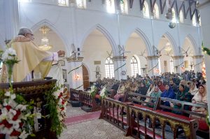 Christian community members performing religious rituals on Christmas Day at St. John Cathedral Church.
