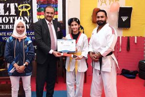 Director of Institute of Food Science Prof. Dr. Anjum Murtaza and Coach Muhammad Naeem Khan distributes certificates to the players during the belt promotion ceremony at Karate Academy, University of Sargodha.