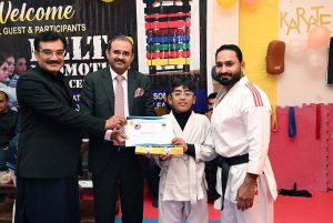 Director of Institute of Food Science Prof. Dr. Anjum Murtaza and Coach Muhammad Naeem Khan distributes certificates to the players during the belt promotion ceremony at Karate Academy, University of Sargodha.