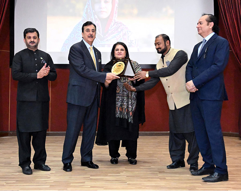 Chairperson Benazir Income Support Programme (BISP), Senator Rubina Khalid, presents a shield to Chairman Senate Syed Yousaf Raza Gillani, in the presence of Secretary BISP Amir Ahmad Ali at BISP Headquarters