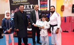 Director of Institute of Food Science Prof. Dr. Anjum Murtaza and Coach Muhammad Naeem Khan distributes certificates to the players during the belt promotion ceremony at Karate Academy, University of Sargodha.