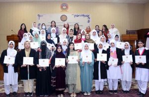 Director of Institute of Food Science Prof. Dr. Anjum Murtaza and Coach Muhammad Naeem Khan distributes certificates to the players during the belt promotion ceremony at Karate Academy, University of Sargodha.