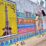 Artists create colorful murals on the walls of Government MC Girls High School Jhal Khanwana