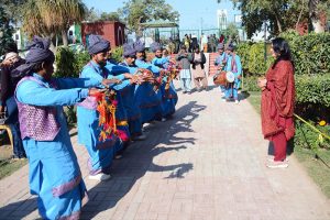 Senior citizens take photos with mobile phones during the Gul-e-Daudi flower exhibition at Qasim Bagh.