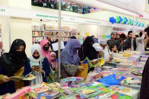 People browse and shop at book stalls on the third day of the Karachi World Book Fair.