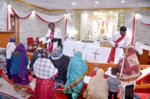 Christian Community members performing religious rituals on Christmas Day at Methodist Church.
