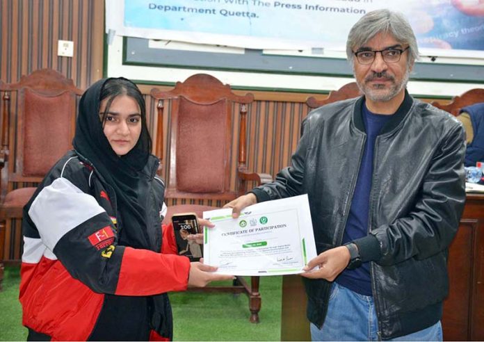 Professor Zerak Naiz distributes certificates to participants at the conclusion of a seminar on countering extremism through digital media literacy, aimed at strengthening youth resilience against disinformation and narrative manipulation, organized by PID Quetta