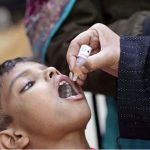 A lady health worker administers polio drops to a child during the “Polio-Free Pakistan” campaign as part of the ongoing immunization drive