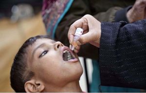 A lady health worker administers polio drops to a child during the “Polio-Free Pakistan” campaign as part of the ongoing immunization drive