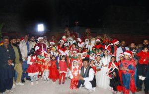 Girls decorate a Christmas tree in a Church at Raza Abad ahead of the upcoming Christmas celebrations.