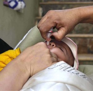 A lady health worker administers polio drops to a child during the “Polio-Free Pakistan” campaign as part of the ongoing immunization drive