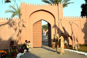 A visitor take picture with mobile phone at the gate of Jilani Park.