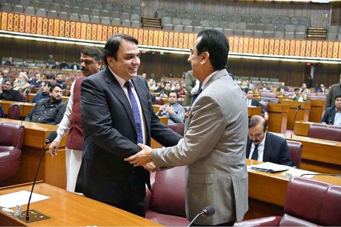 Chairman Senate, Syed Yousaf Raza Gilani shaking hands with Senator Mohammad Abdul Qadir during Joint Session of Parliament at Parliament House