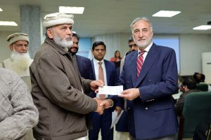 Chairman NAB Lt. Gen. (Retd) Nazir Ahmed addresses the affected individuals of the Suzuki Sialkot Motors case during a cheque distribution ceremony.