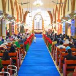 Christian community members performing religious rituals on Christmas Day at St. Thomas Church.