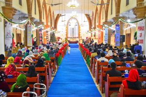 Christian community members performing religious rituals on Christmas Day at St. Thomas Church.