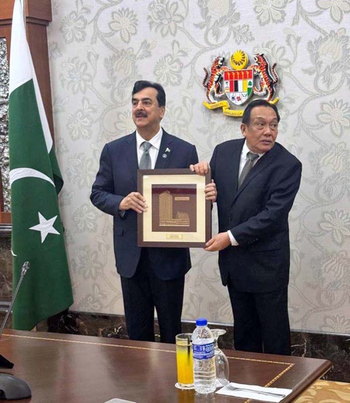 President of the senate of Malaysia, His Excellency Senator Dato Awang Bemee Bin Awang Ali Basah presenting souvenir to Chairman Senate of Pakistan, Syed Yousaf Raza Gilani