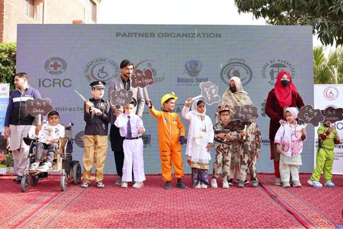 Young children perform a tableau for differently-abled persons during a ceremony marking the International Day of Persons with Disabilities, organized by the Paraplegic Centre Peshawar in collaboration with the International Committee of the Red Cross