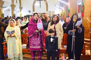 Christian community members performing religious rituals on Christmas Day at St. Thomas Church.