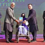 Provincial Health Minister Mian Khaleeq-ur-Rehman, along with the heads of the ICRC and the Paraplegic Centre, presents an appreciation shield to a young differently-abled participant during the International Day of Persons with Disabilities at the Paraplegic Centre