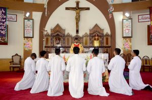 Christian community members performing religious rituals on Christmas Day at Catholic Church Railway Road.