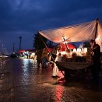 A vendor selling peanuts along Srinagar highway in Bhara kahu during the first spell of rain in capital.