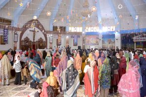 Christian community members performing religious rituals on Christmas Day at Catholic Church Railway Road.