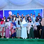 Prime Minister Muhammad Shehbaz in a group photo with the recipients of laptops. APP/ABB