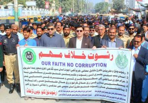 Commissioner Larkana Division, Tahir Hussain Sangi leads participants in a rally marking Anti-Corruption Week at DC Office Road.