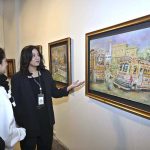 Visitors taking keen interest in an artwork by an artist BARKAT on special needs, who graduated as Fine Artist from NCA Lahore, on display at the NCA Islamabad Campus during an exhibition on the eve of International Day of persons with Disabilities