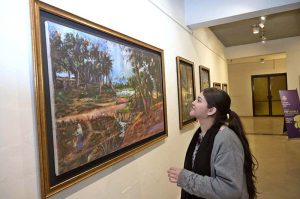 Visitors taking keen interest in an artwork by an artist BARKAT on special needs, who graduated as Fine Artist from NCA Lahore, on display at the NCA Islamabad Campus during an exhibition on the eve of International Day of persons with Disabilities