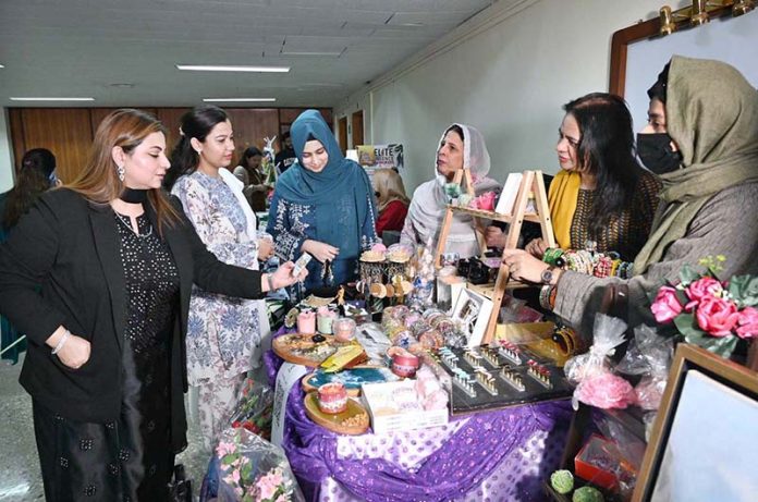 Women visiting a handicraft exhibition at the ceremony on the theme of Empowered Women for a Prosperous Pakistan at the State Bank of Pakistan Building