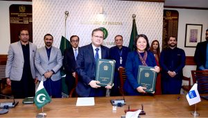 Secretary Economic Affairs Division, Muhammad Humair Karim, and Country Director of the Asian Development Bank, Emma Fan, display the signed documents between Pakistan and ADB.