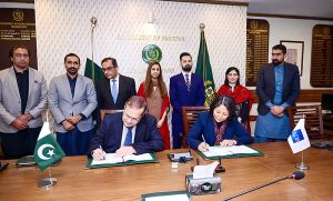 Secretary Economic Affairs Division, Muhammad Humair Karim, and Country Director of the Asian Development Bank, Emma Fan, display the signed documents between Pakistan and ADB.