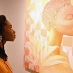 A foreign visitor viewing an artwork on display at International Art Exhibition during World Culture Festival
