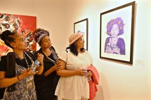 A foreign visitor viewing an artwork on display at International Art Exhibition during World Culture Festival
