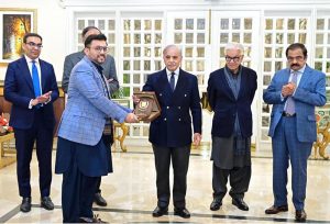 Prime Minister Muhammad Shehbaz Sharif presents shields to the members of government team which led the privatisation of PIA.