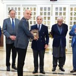 Prime Minister Muhammad Shehbaz Sharif presents shields to the members of government team which led the privatisation of PIA.