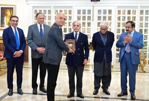 Prime Minister Muhammad Shehbaz Sharif presents shields to the members of government team which led the privatisation of PIA.
