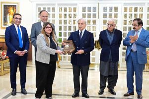 Prime Minister Muhammad Shehbaz Sharif presents shields to the members of government team which led the privatisation of PIA.