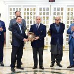 Prime Minister Muhammad Shehbaz Sharif presents shields to the members of government team which led the privatisation of PIA.