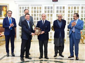 Prime Minister Muhammad Shehbaz Sharif presents shields to the members of government team which led the privatisation of PIA.