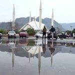 A view of Faisal Masjid’s reflection in the water accumulated on road in front of Faisal Masjid after rain in the twin cities.