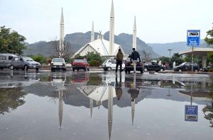 A view of Faisal Masjid’s reflection in the water accumulated on road in front of Faisal Masjid after rain in the twin cities.