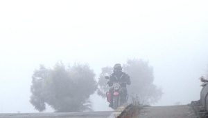 Motorcyclist pass through dense fog in the early morning along the expressway in the Federal Capital.