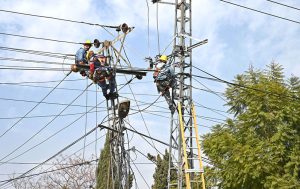 IESCO staffers are busy repairing electricity wires on a pole to restore power in the Banni area.