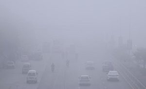 Motorcyclist pass through dense fog in the early morning along the expressway in the Federal Capital.