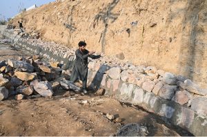 Labourers are busy with construction work near 10th Avenue as part of development activities in the Federal Capital