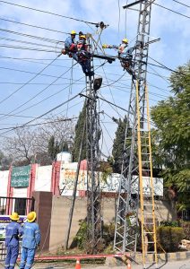 IESCO staffers are busy repairing electricity wires on a pole to restore power in the Banni area.